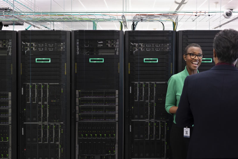 Woman and man standing in a room of HPE servers